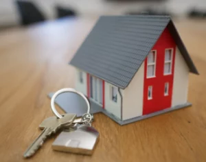 Miniature home with keys at table